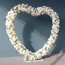 Load image into Gallery viewer, White flower heart-shaped wedding arch backdrop stand with floral decorations for ceremony