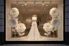 Load image into Gallery viewer, Wedding dress store window display with white flowers
