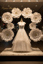 Load image into Gallery viewer, Luxury wedding dress window display with white flowers
